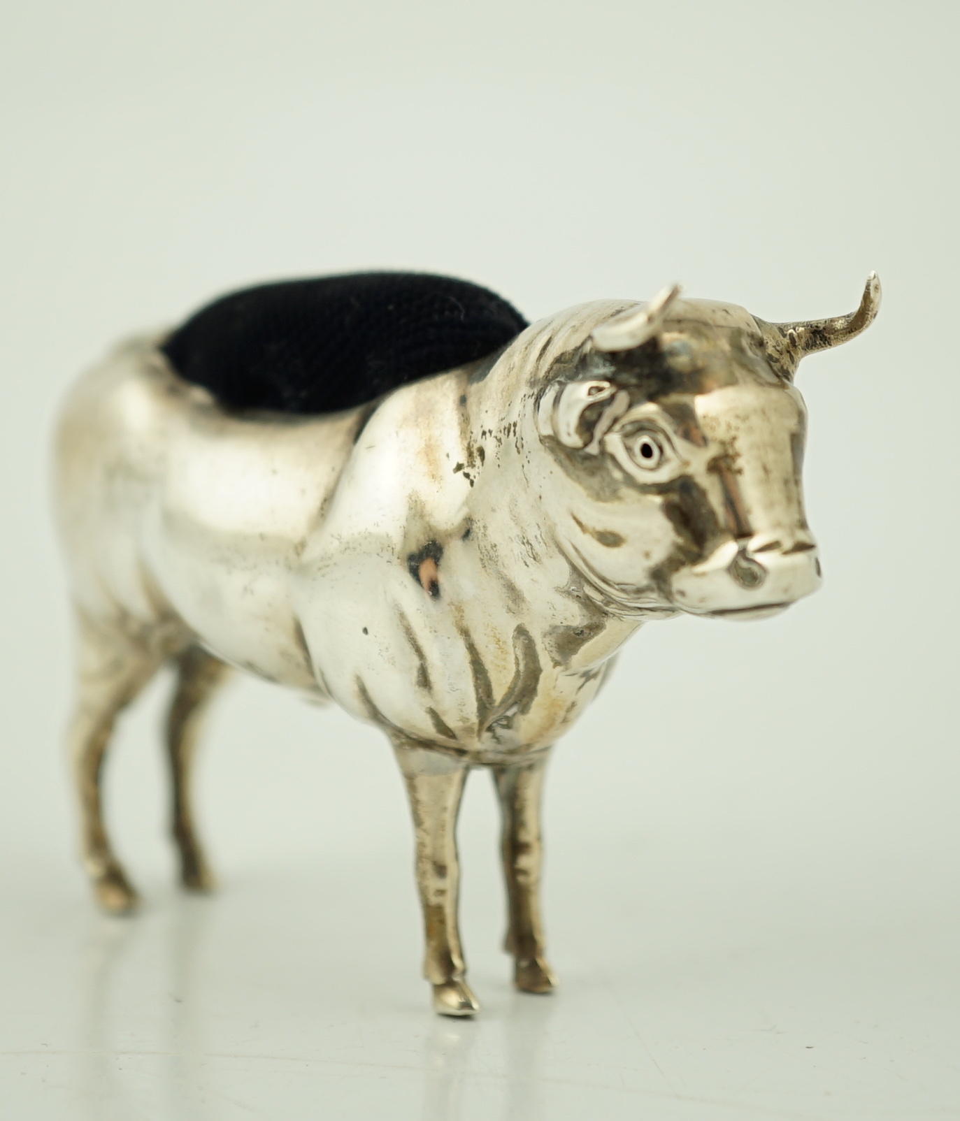 An Edwardian novelty silver pin cushion, modelled as a bull, Cohen & Charles